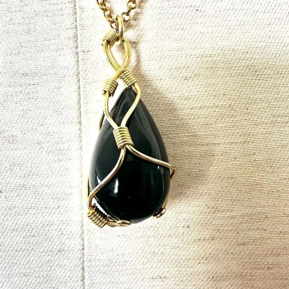 Gold tone black pendant necklace